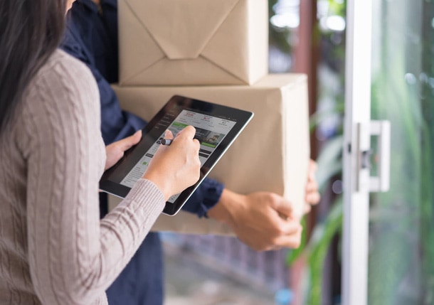 woman signing for package